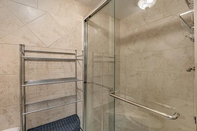 a bathroom with a glass shower door