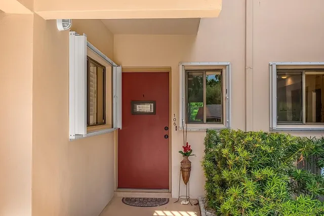 front view of a house with a potted plant