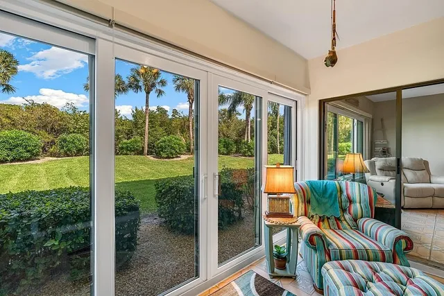a view of a porch with furniture and backyard
