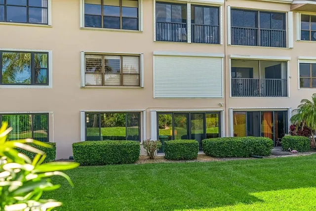 a front view of a building with a garden
