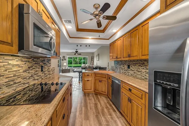 a kitchen with wooden cabinets and stainless steel appliances