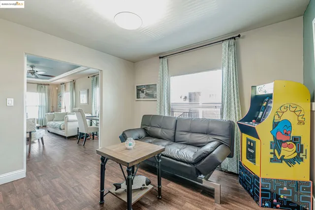 a living room with furniture and a wooden floor