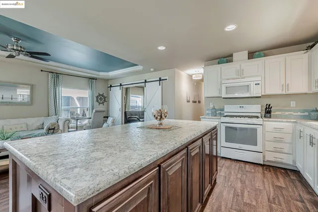 a kitchen with stainless steel appliances granite countertop stove top oven and cabinets