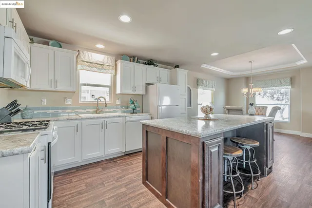 a kitchen with a stove a sink and a refrigerator