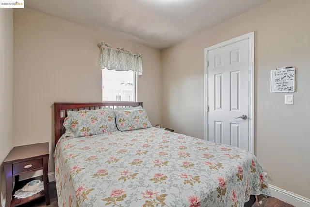 a bedroom with a large bed and a window