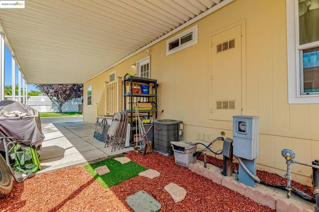 a view of a patio with table and chairs and potted plants