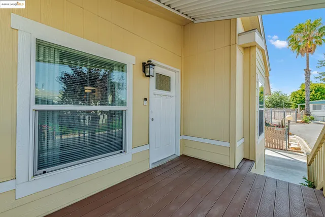a view of front door and porch with wooden floor