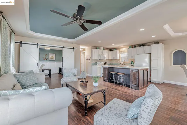 a living room with furniture and kitchen view
