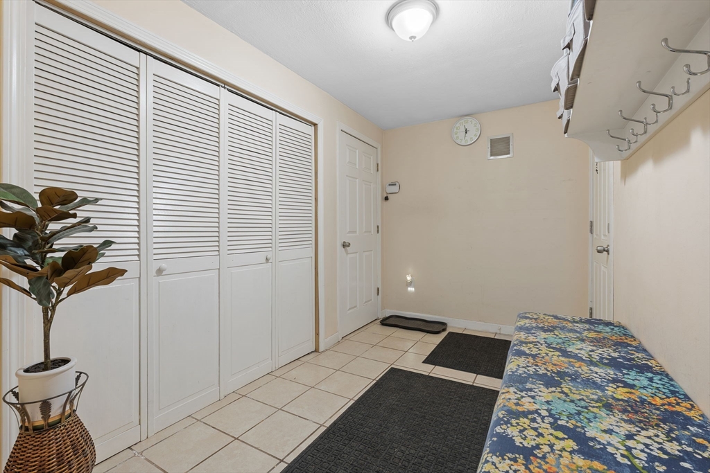 2 Brandywine Drive Hooksett, NH 03106 - Photo 32 of 42 a bedroom with a bed and a chandelier