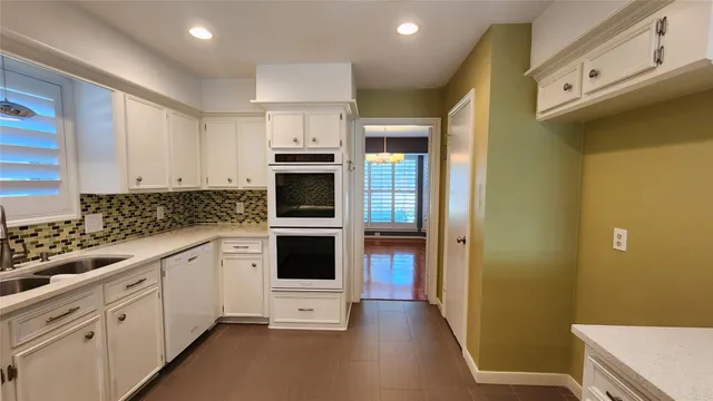 a kitchen with cabinets and white appliances