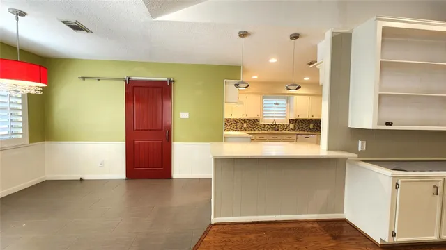 a view of kitchen with granite countertop cabinets and sink