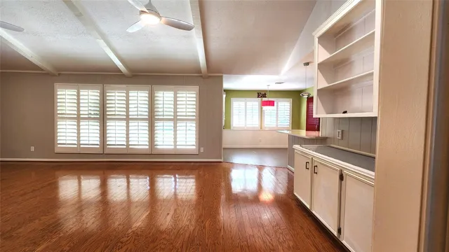 a view of a kitchen with wooden floor and stainless steel appliances