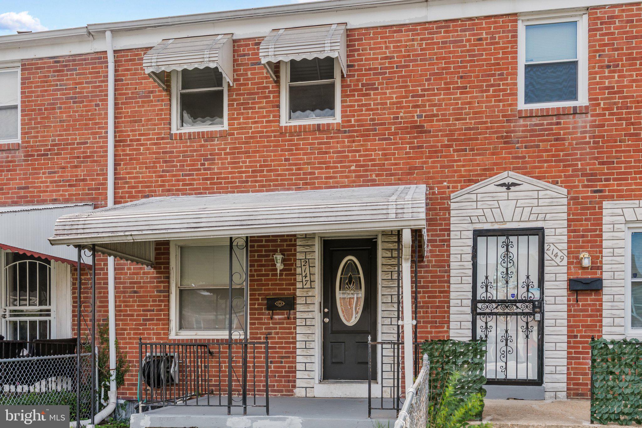 Charming brick facade with inviting porch.
