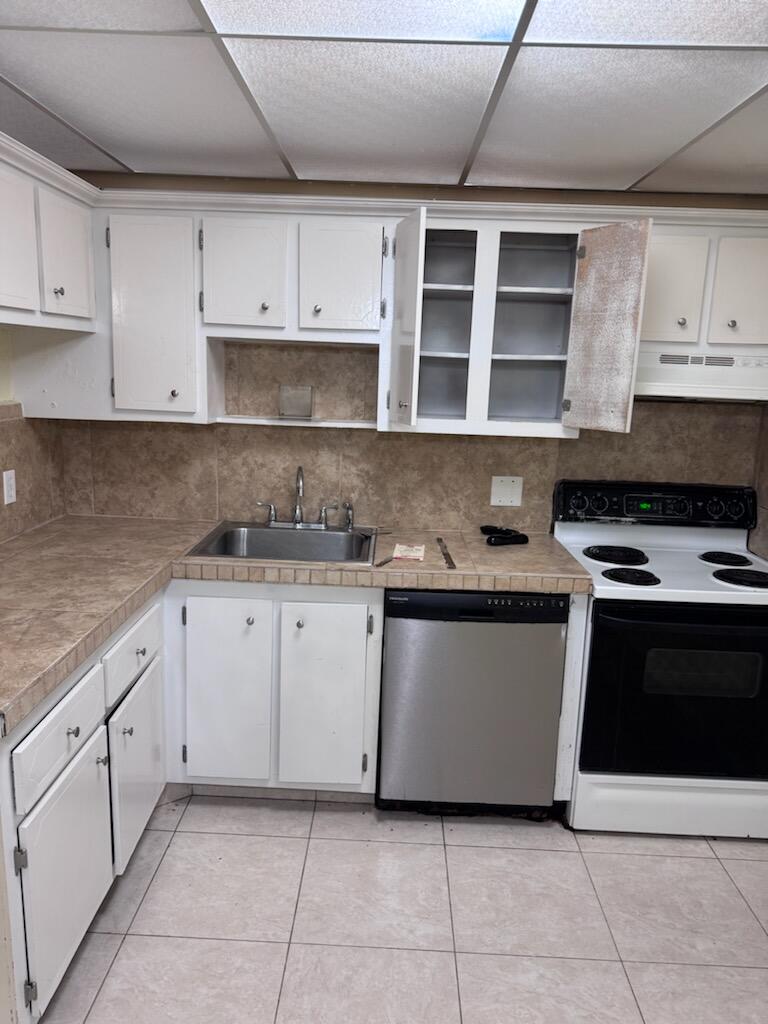 1010 Country Club Drive, Unit 108 Margate, FL 33063 - Photo 1 of 19 a kitchen with granite countertop white cabinets and stainless steel appliances