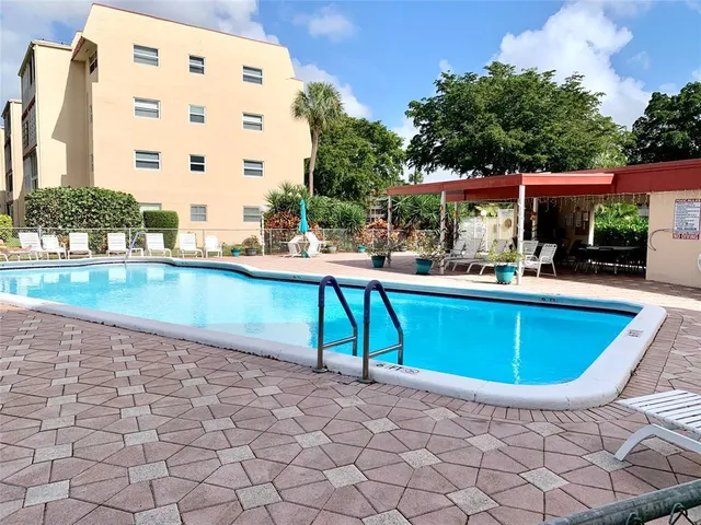a swimming pool with outdoor seating and yard