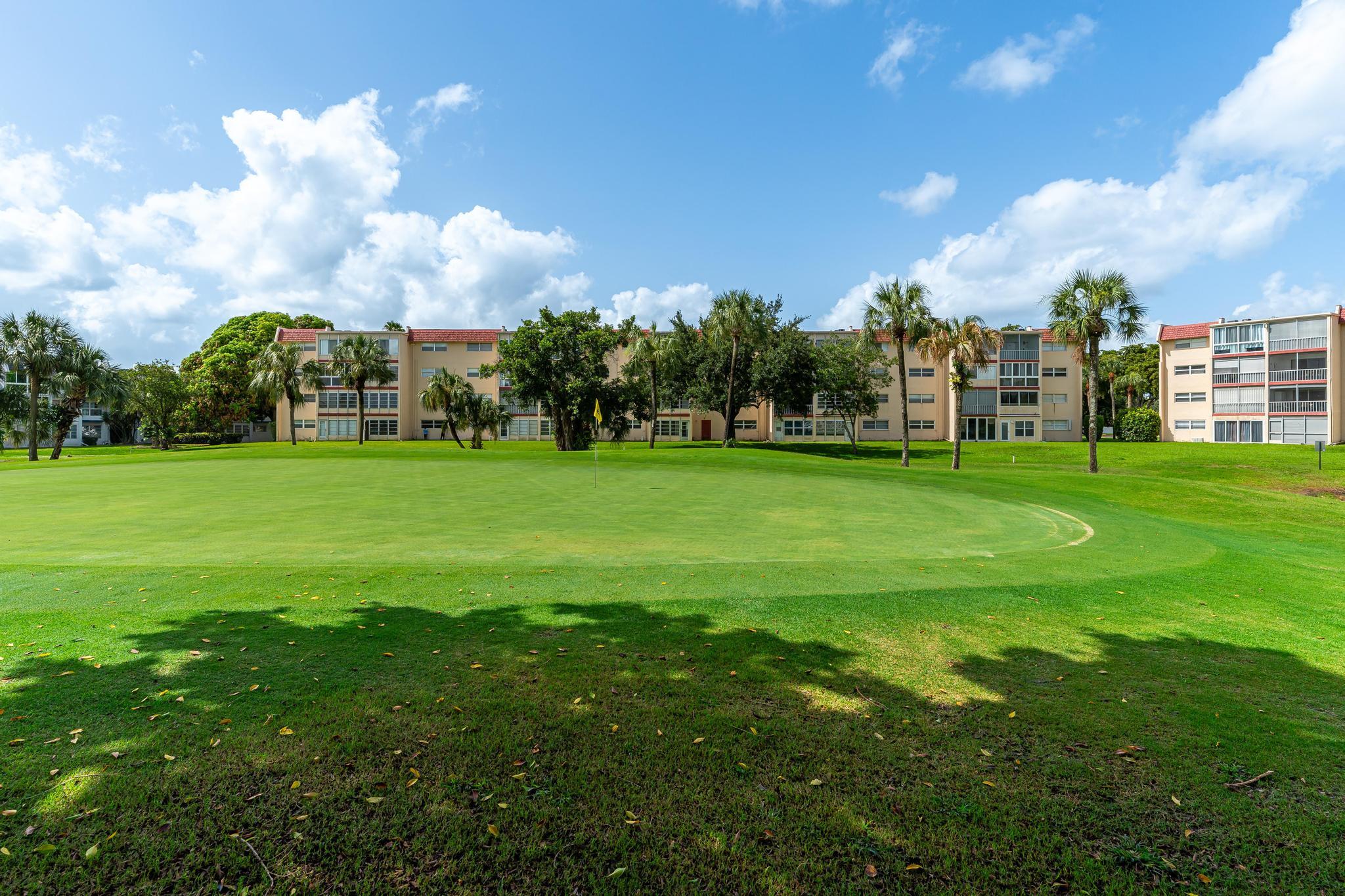 1010 Country Club Drive, Unit 108 Margate, FL 33063 - Photo 19 of 19 a view of a building with a big yard