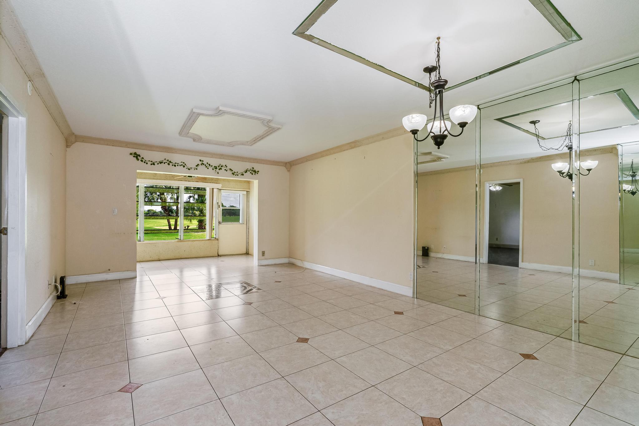 1010 Country Club Drive, Unit 108 Margate, FL 33063 - Photo 2 of 19 a view of a livingroom with a chandelier and furniture