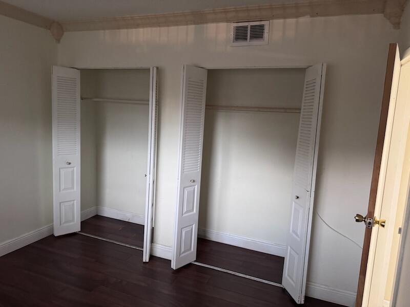 1010 Country Club Drive, Unit 108 Margate, FL 33063 - Photo 6 of 19 an empty room with wooden floor and closet