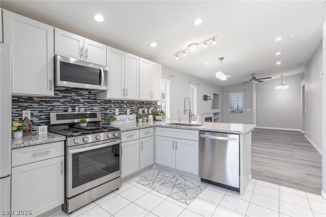 2254 Ramsgate Drive Henderson, NV 89074 - Photo 11 of 43 Culinary delights await in this modern kitchen with granite countertops and sleek stainless steel appliances.