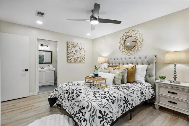 a bedroom with bed and wooden floor