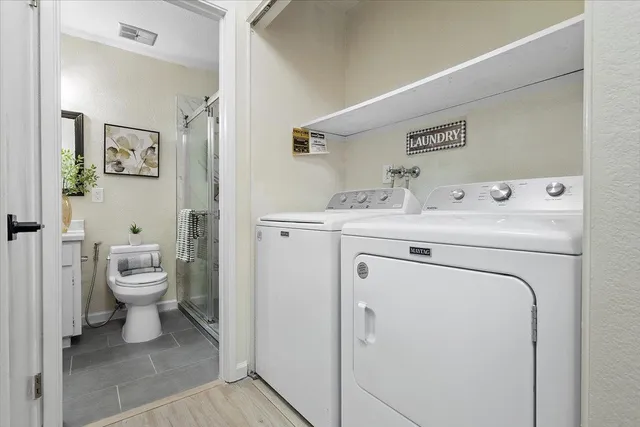 a view of bathroom with a washer and dryer