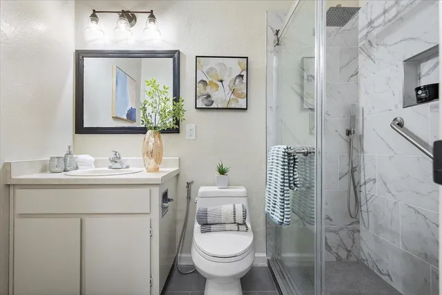 a bathroom with a toilet sink and mirror