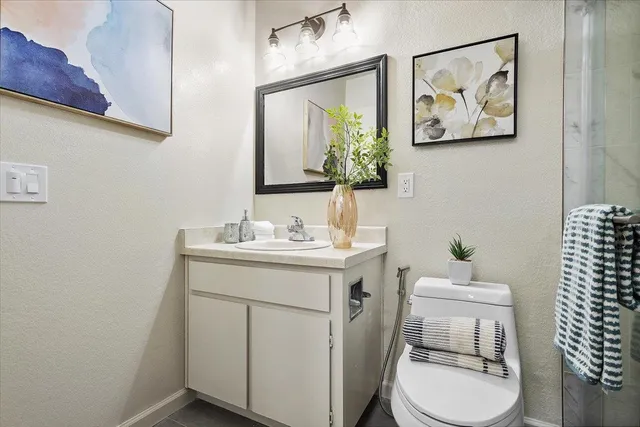 a bathroom with a sink mirror and toilet