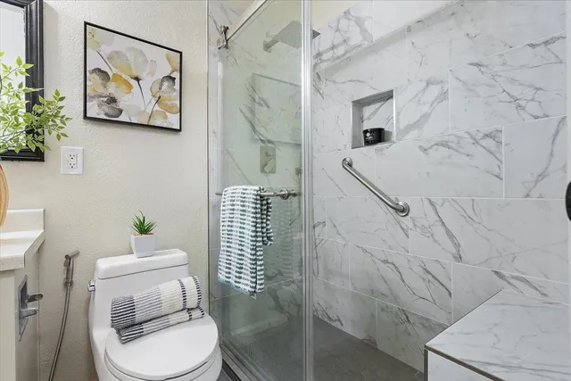 a white toilet sitting next to a bathroom sink