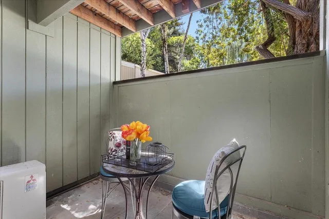 a view of a room with furniture and wooden floor