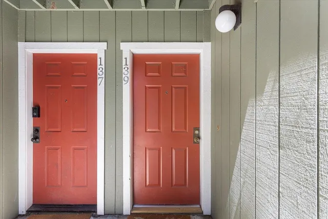 an entryway door with wooden floor