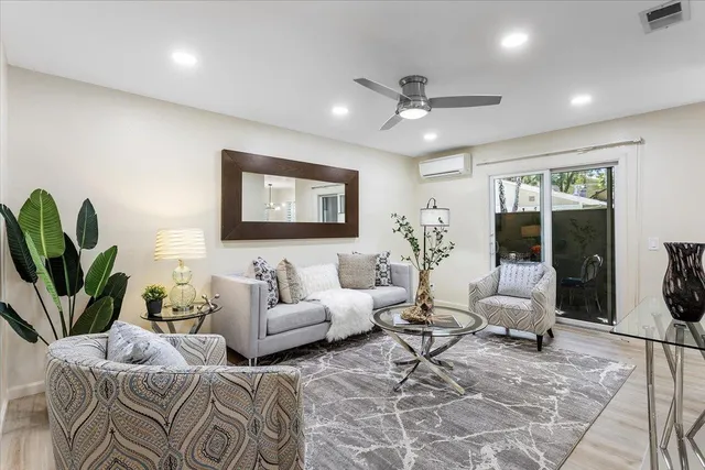 a living room with furniture potted plant and a window