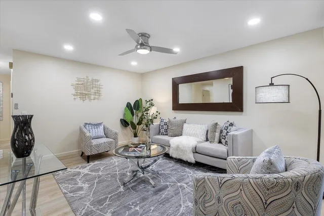 a living room with furniture and a potted plant
