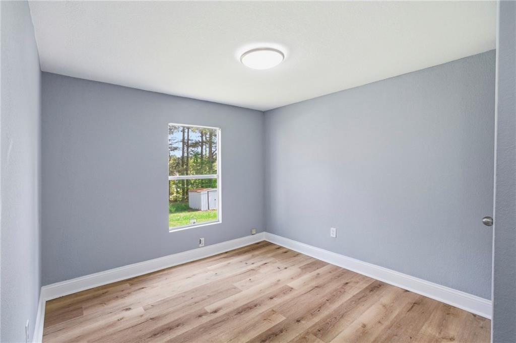 109 Webb Drive Northeast Calhoun, GA 30701 - Photo 20 of 49 a view of an empty room with wooden floor and a window