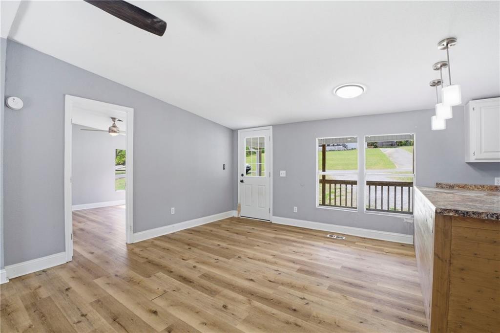 109 Webb Drive Northeast Calhoun, GA 30701 - Photo 27 of 49 an empty room with wooden floor and windows