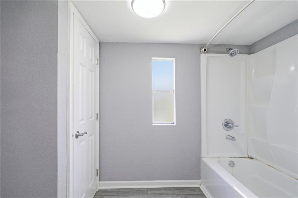 109 Webb Drive Northeast Calhoun, GA 30701 - Photo 37 of 49 a bathroom with a bathtub and a shower