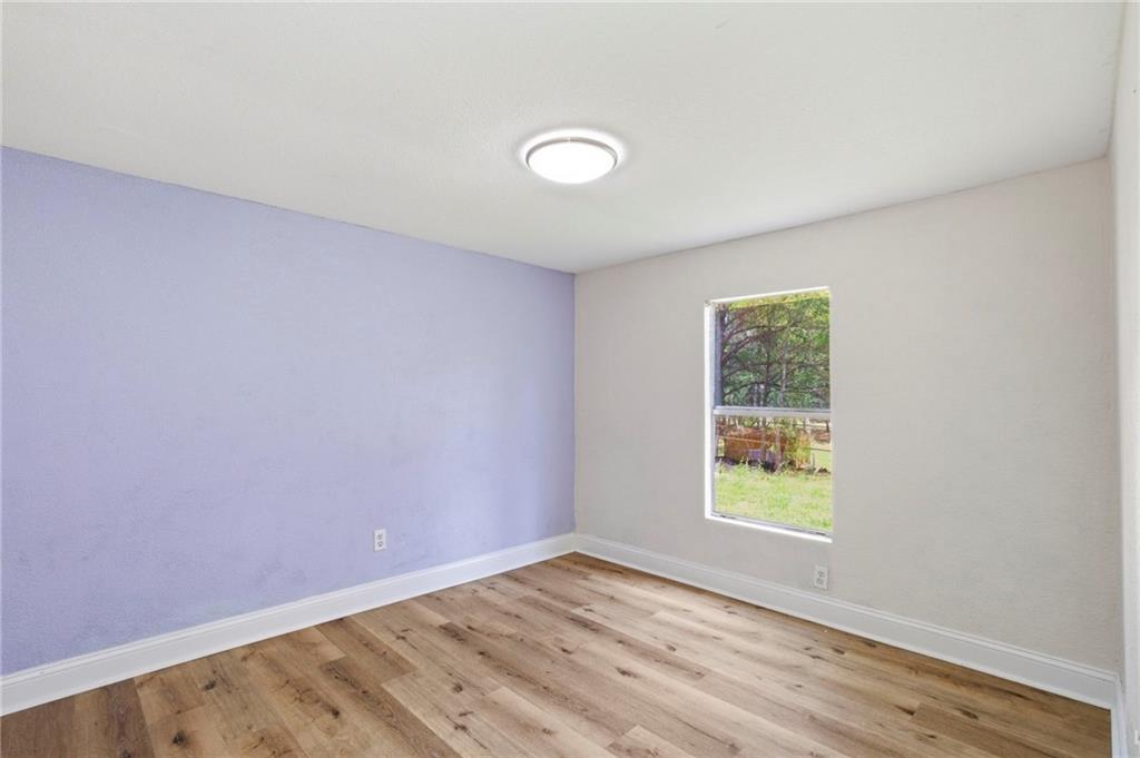 109 Webb Drive Northeast Calhoun, GA 30701 - Photo 49 of 49 an empty room with wooden floor and windows
