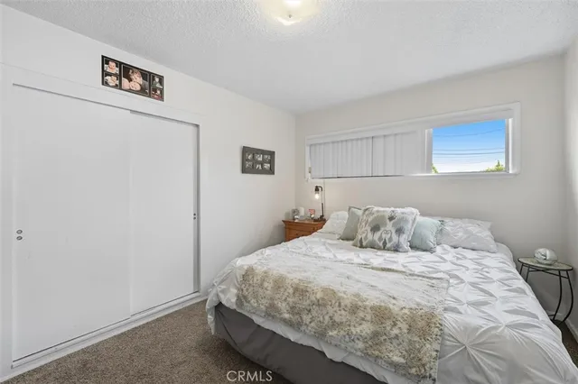 a bedroom with a bed and a wall painting