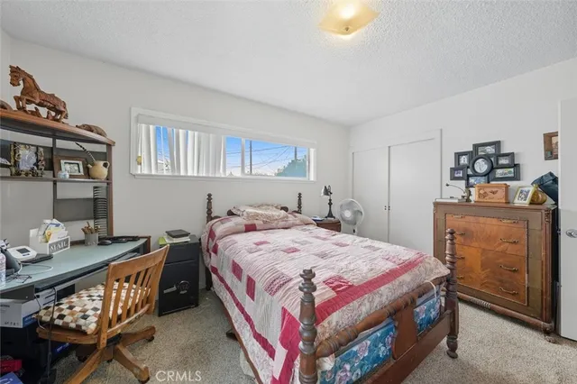 a bedroom with a bed and a dresser in it