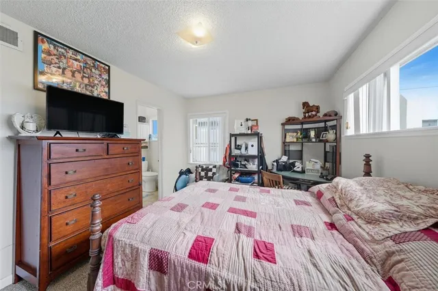 a bedroom with a bed and a flat screen tv in it