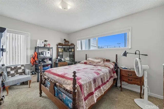 a bedroom with a bed and a tv