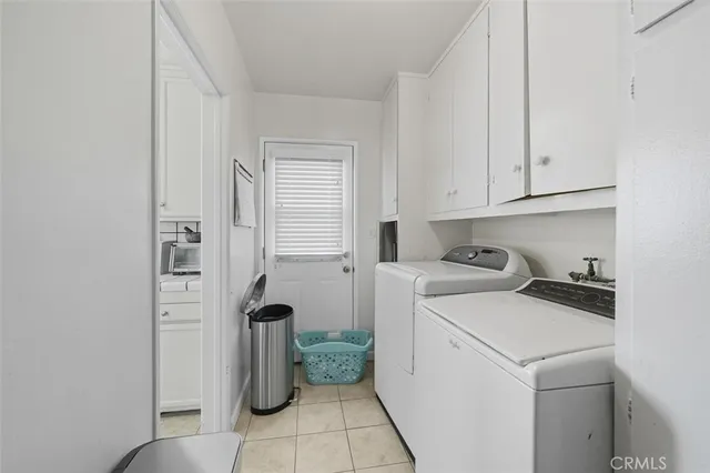 a view of storage and utility room with washer and dryer