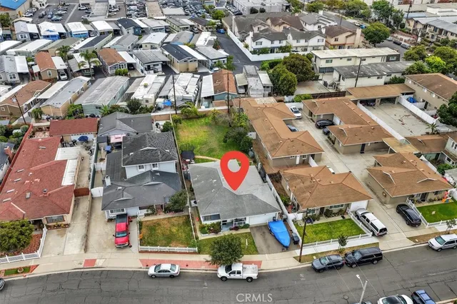 an aerial view of residential houses with outdoor space and parking