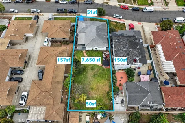 an aerial view of a house with a yard and a large pool