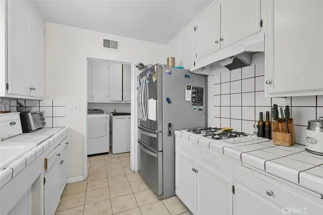 a kitchen with refrigerator a stove a sink dishwasher and a refrigerator