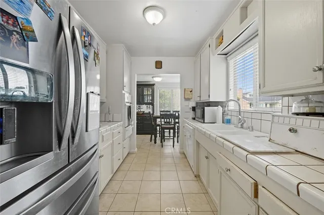a large white kitchen with cabinets