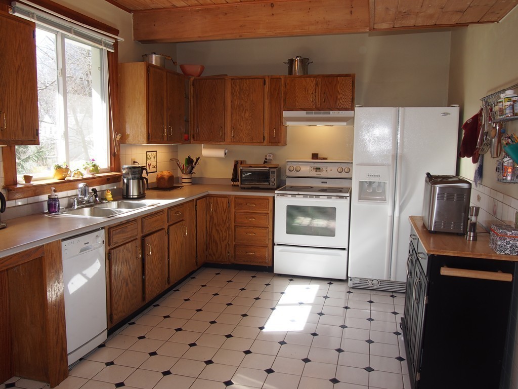 78 Beaconsfield Road Worcester, MA 01602 - Photo 12 of 30 a kitchen with a sink a stove top oven and refrigerator