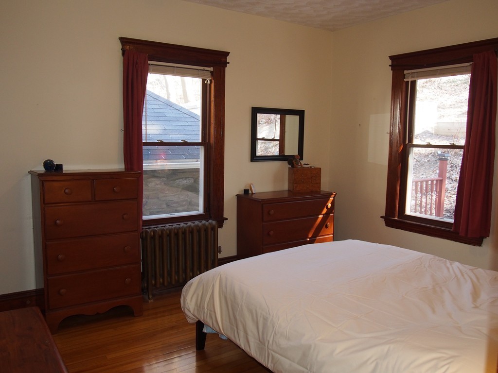 78 Beaconsfield Road Worcester, MA 01602 - Photo 16 of 30 a bed sitting in a bedroom next to a window