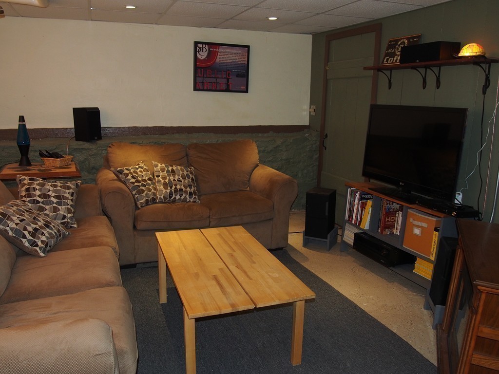 78 Beaconsfield Road Worcester, MA 01602 - Photo 24 of 30 a living room with furniture and a flat screen tv
