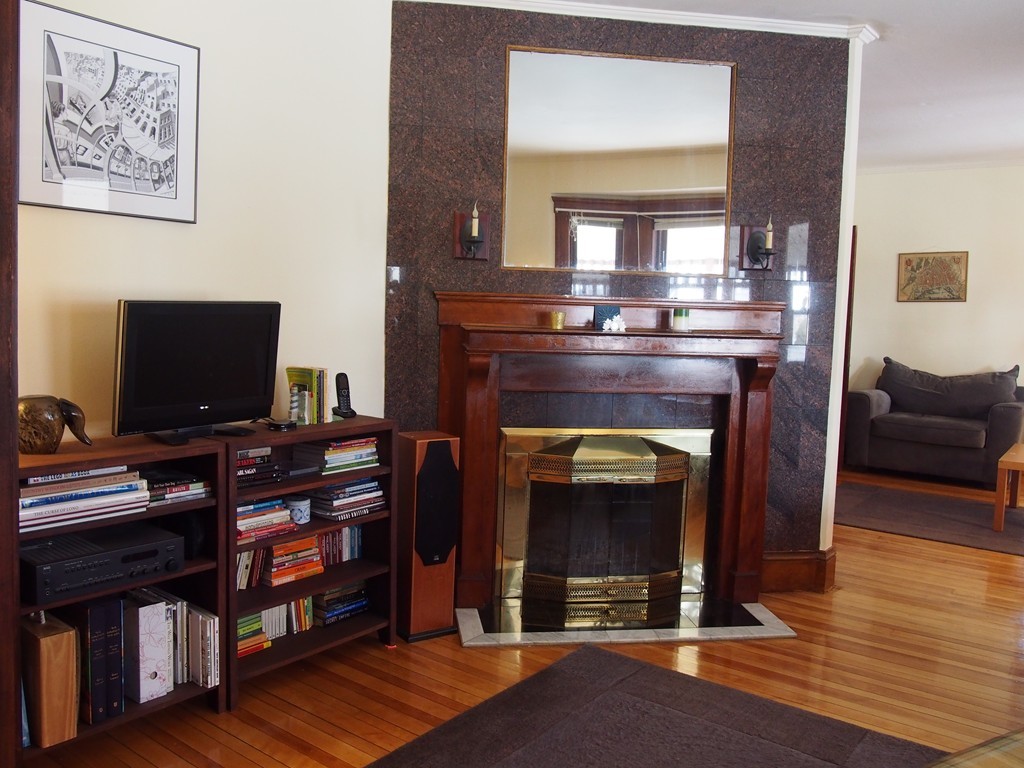 78 Beaconsfield Road Worcester, MA 01602 - Photo 3 of 30 a living room with fireplace and a flat screen tv