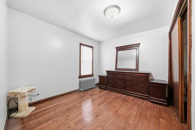 a room with a dresser and a window